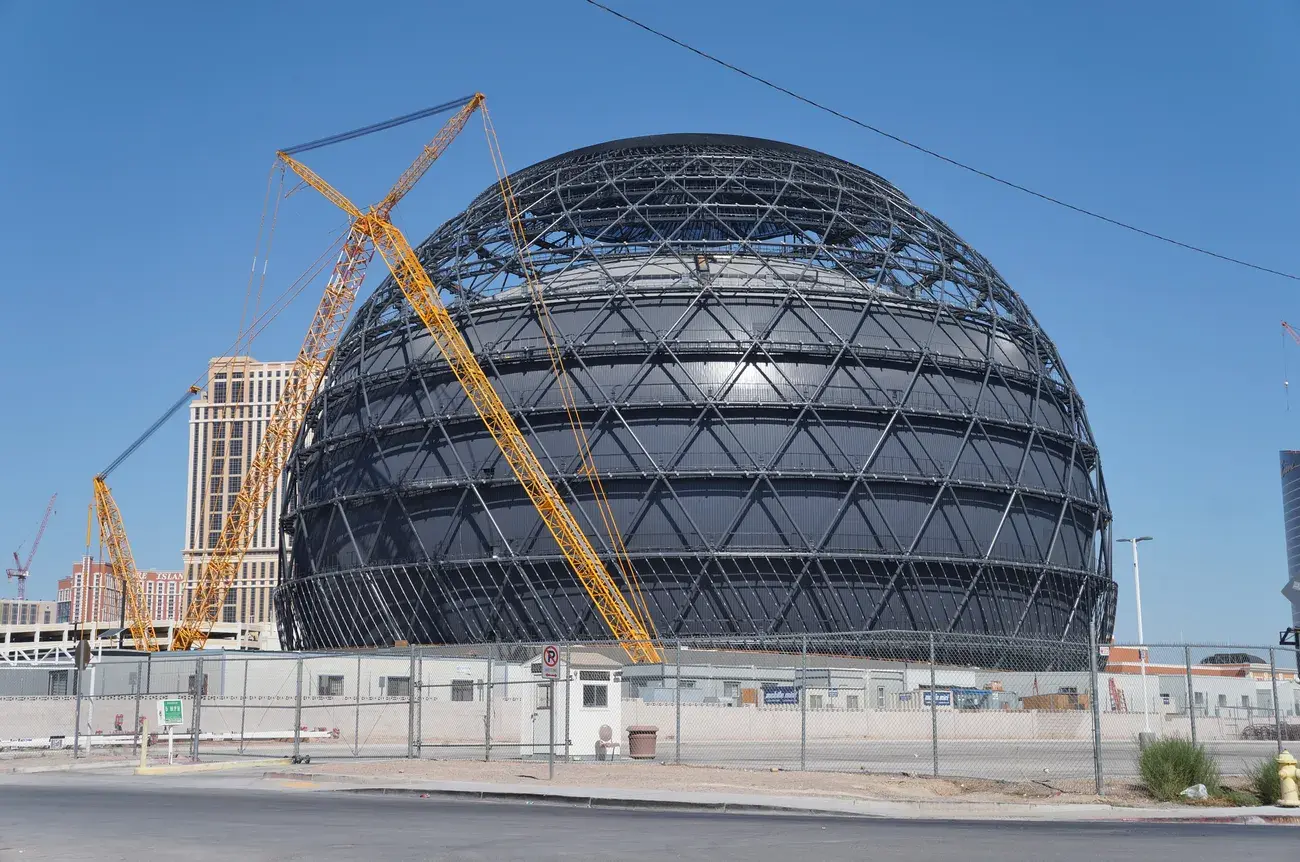 The bare geodesic steel shell of the Sphere in Las Vegas with a crane, before its LED skin, 2022.